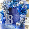 A backdrop of blue and silver balloons and grapes decorated with the number 18 for a party