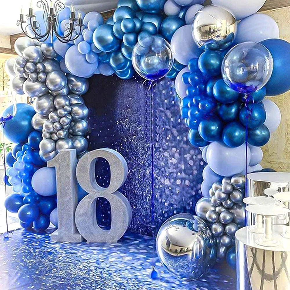 A backdrop of blue and silver balloons and grapes decorated with the number 18 for a party