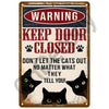 A vintage metal sign with a warning that reads Keep Door Closed and Don't Let the Cats Out.
