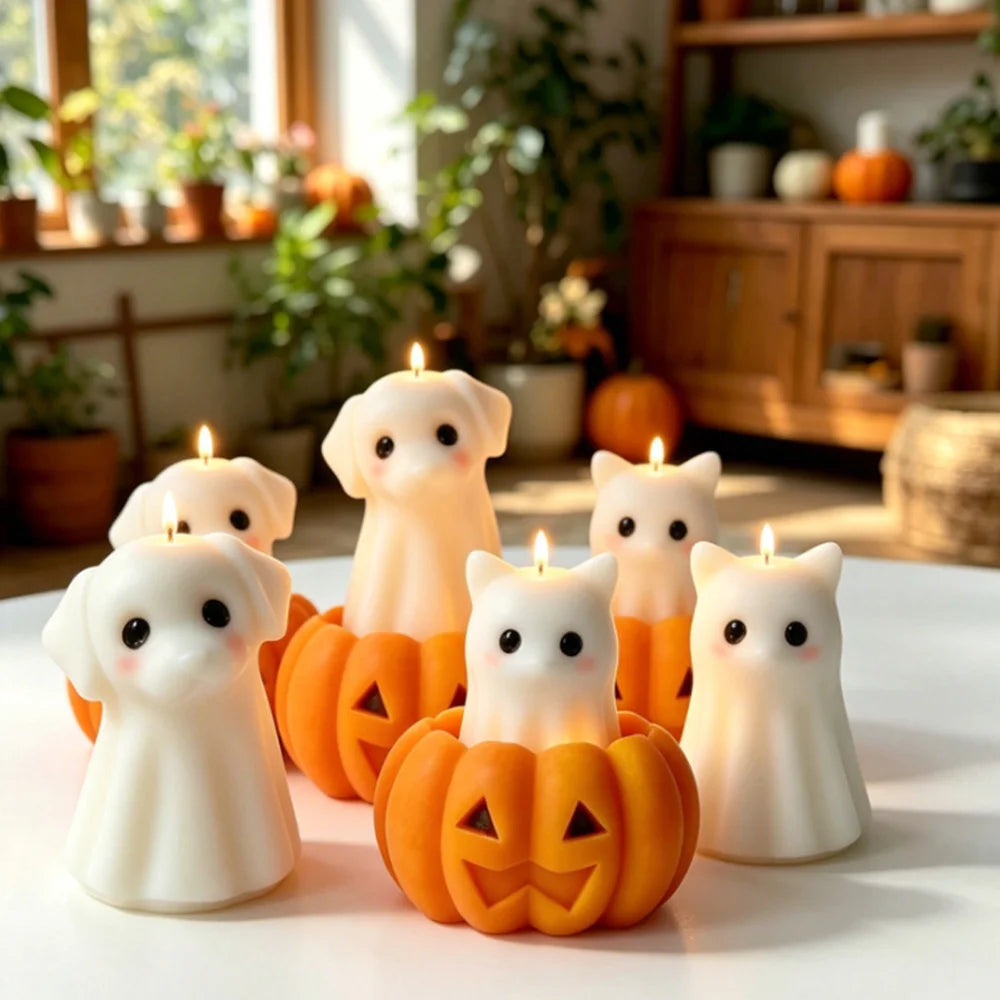 A collection of silicone candle molds shaped like cute ghosts, cats, dogs, and pumpkins displayed on a white surface.