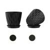 A set of six round black plastic plant pots with drainage saucers.