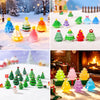 A collection of colorful mini 3D Christmas tree resin charms in various shades and shapes on a white surface.