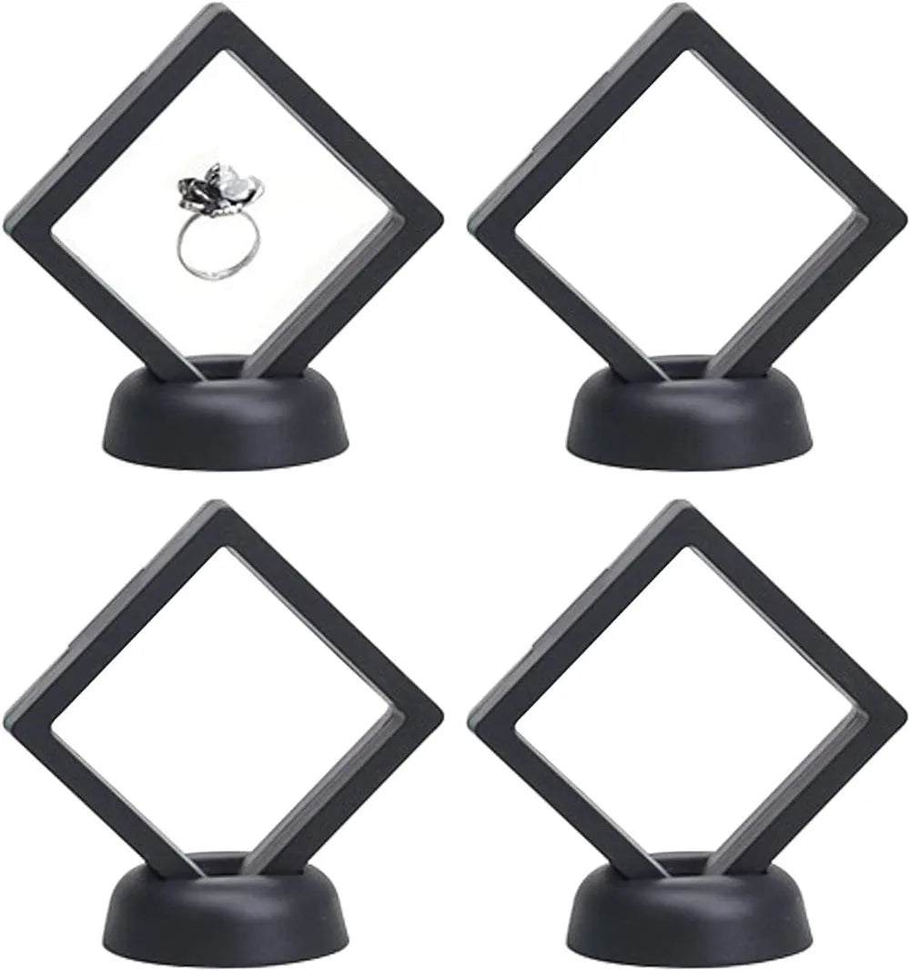A set of black floating shadow box jewelry display frames with diamond shapes, featuring a silver ring inside.