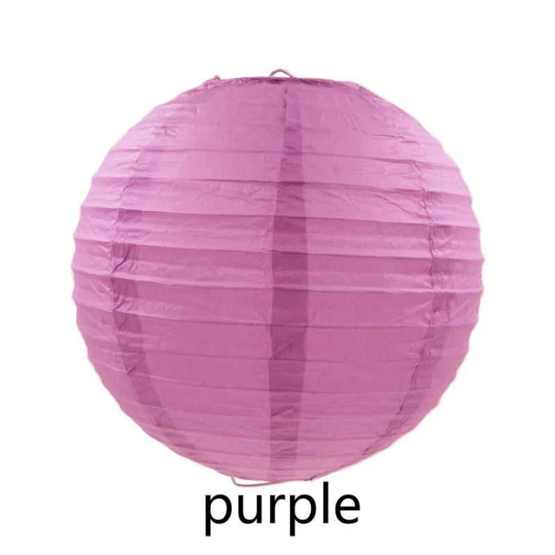 A large, round pink paper lantern with vertical folds.