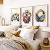 Three framed canvas prints featuring gaming controllers and headphones displayed on a white wall.