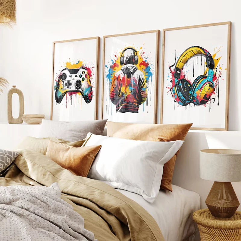 Three framed canvas prints featuring gaming controllers and headphones displayed on a white wall.