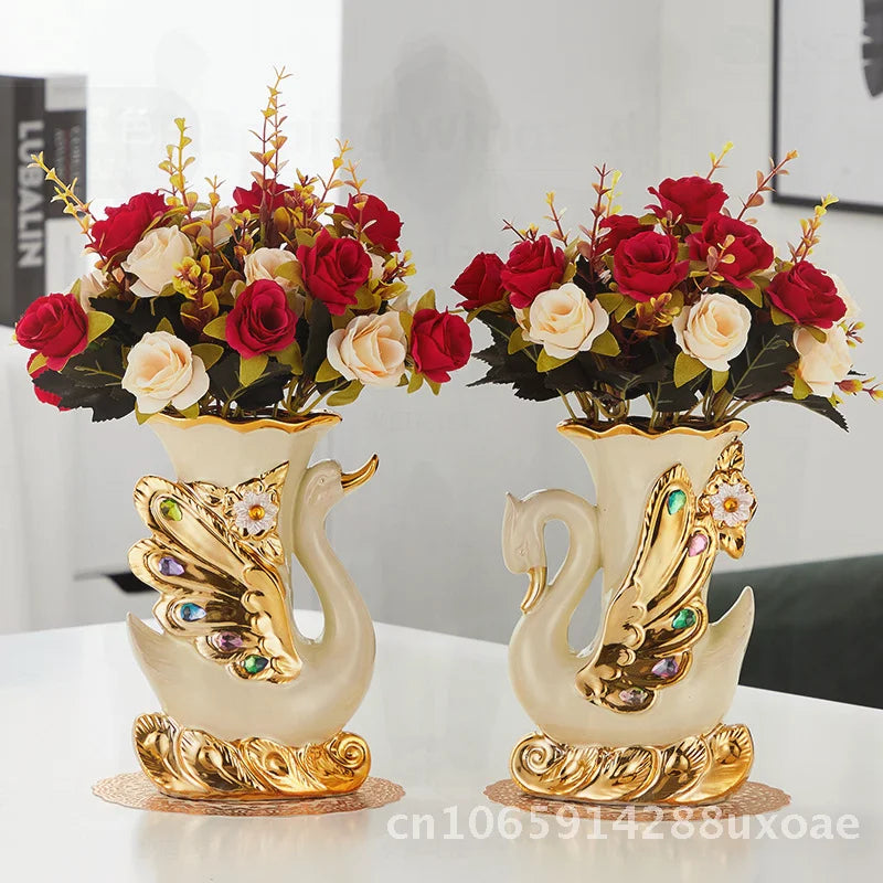 A pair of elegant ceramic swan vases with floral arrangements for modern home decor.