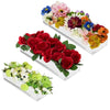 A display of colorful mixed flowers arranged in clear acrylic rectangular vases.