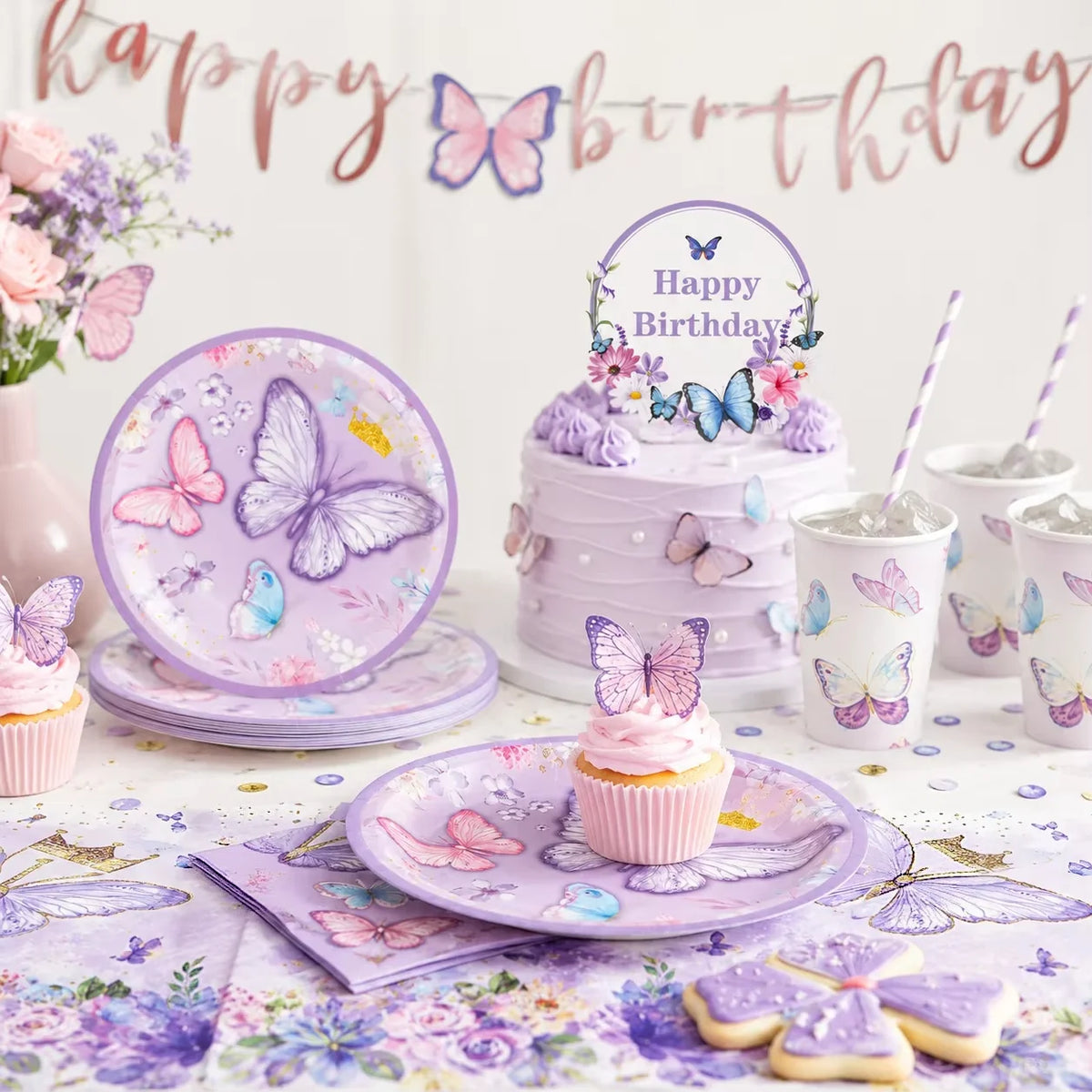A purple and pink butterfly theme disposable party set featuring plates, cupcakes, and decorations.