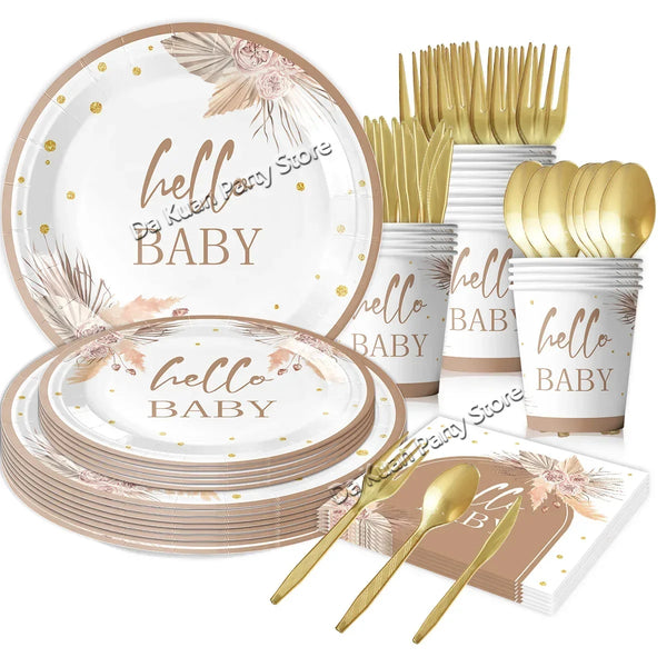 A set of gold and white tableware including plates, forks, spoons, and cups for a baby shower or gender reveal event.