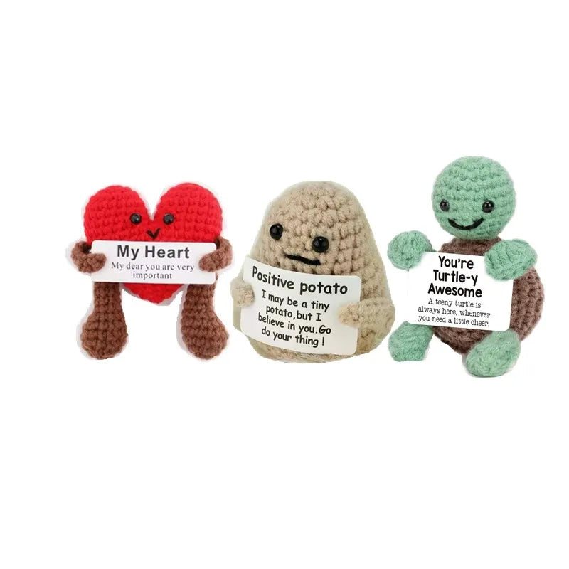 Three handmade knitted plush dolls with hearts and text on them for cozy decor