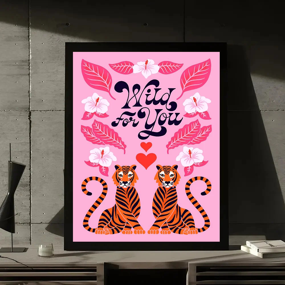 A framed wall art print featuring a pink background with a wild for you quote, leaves, and tiger illustrations.