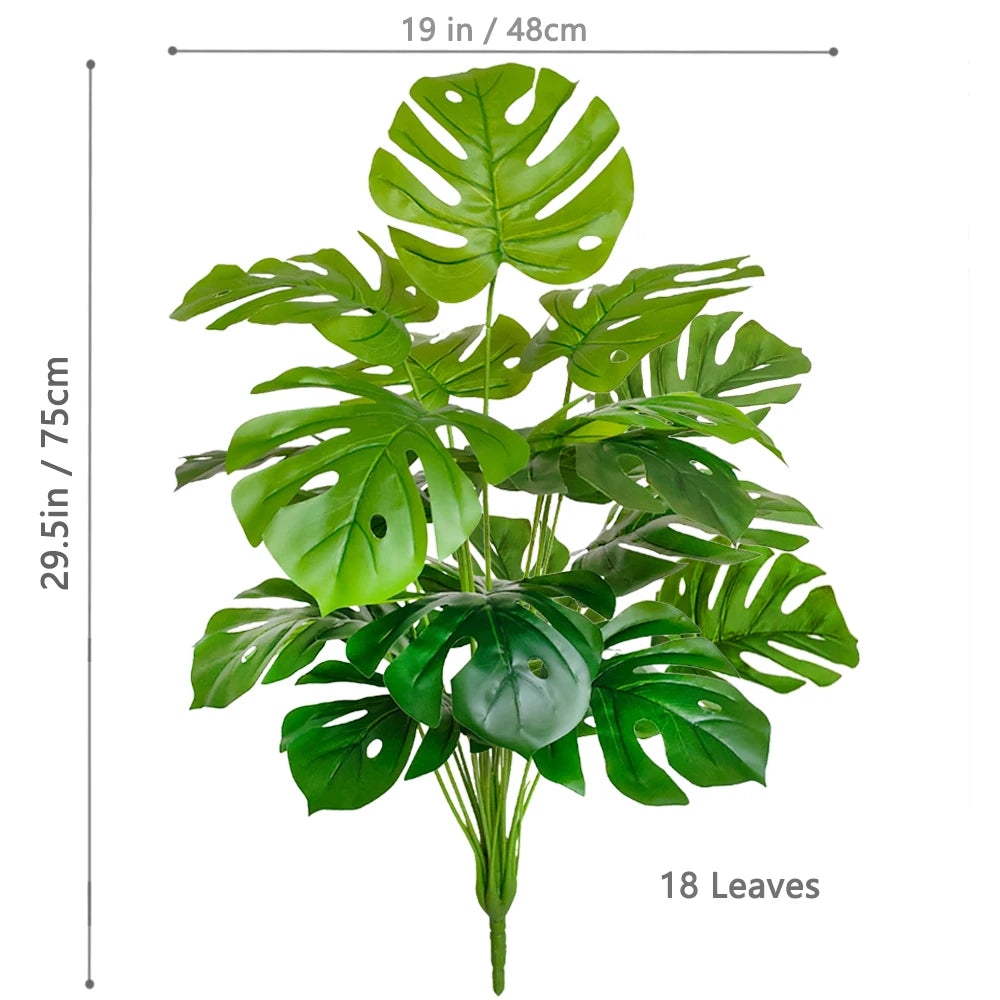 Artificial Monstera plant with silk green leaves displayed against a white background.