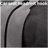 Close-up of a car seat headrest hook, showing the leather strap and stitching.