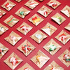 Assorted Christmas resin fridge magnets featuring Santa, snowman, and tree designs on kraft paper