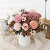 A bouquet of silk autumn roses and hydrangea flowers in shades of pink, cream, and mauve.
