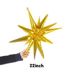 A hand is holding a gold star burst foil balloon against a white background.