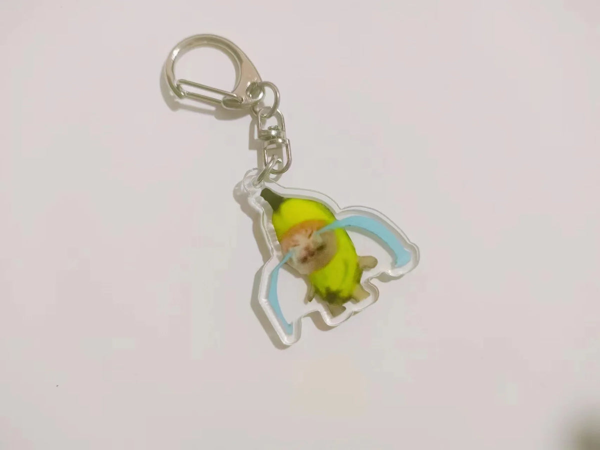 Acrylic keychain featuring a yellow banana cat design with light blue accents.