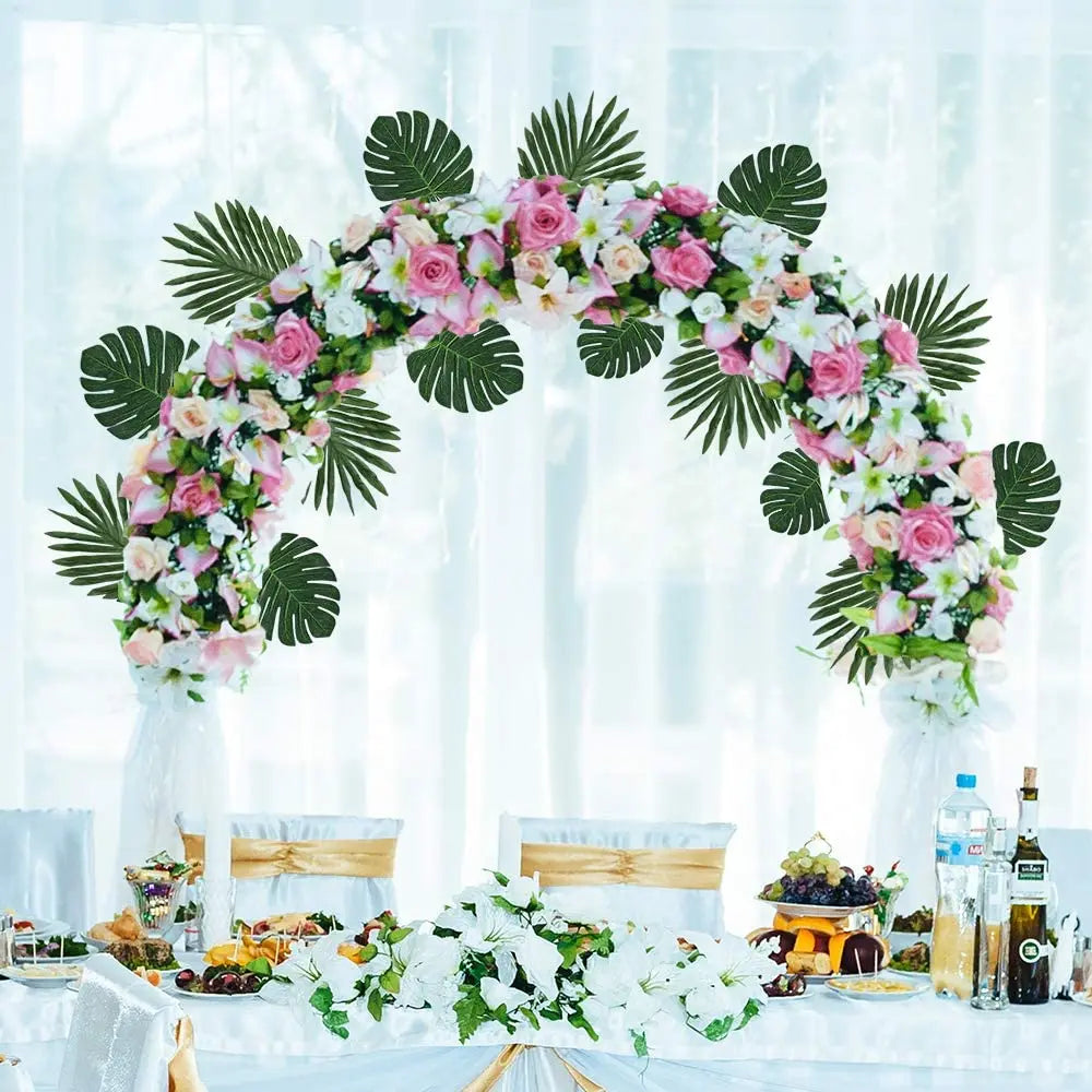 A floral arch decorated with pink and white flowers and green palm leaves for party decor
