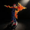 A figurine of a character with red hair engulfed in bright orange flames, displayed against a dark background.