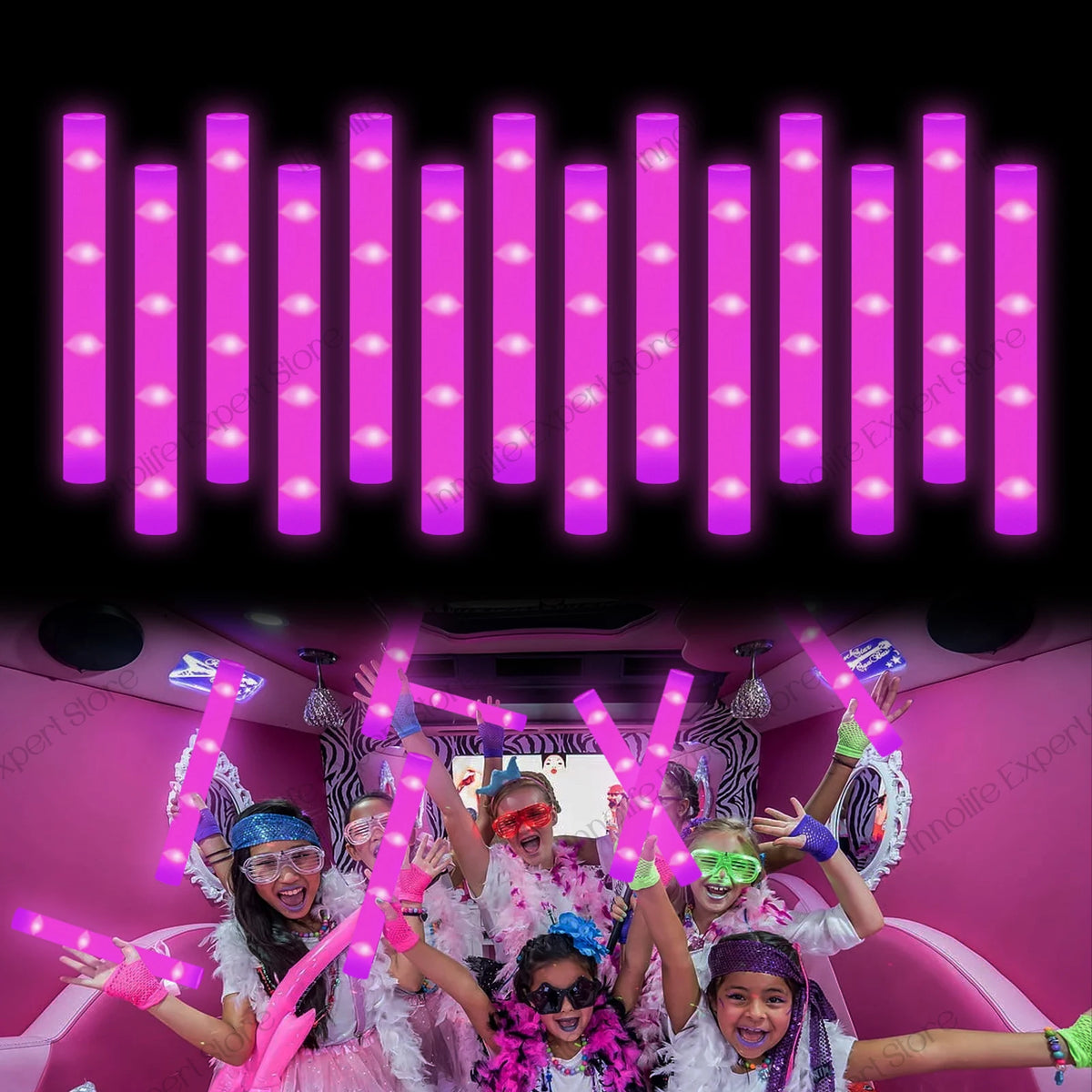 A group of people celebrating with pink LED foam glow sticks illuminating the background.