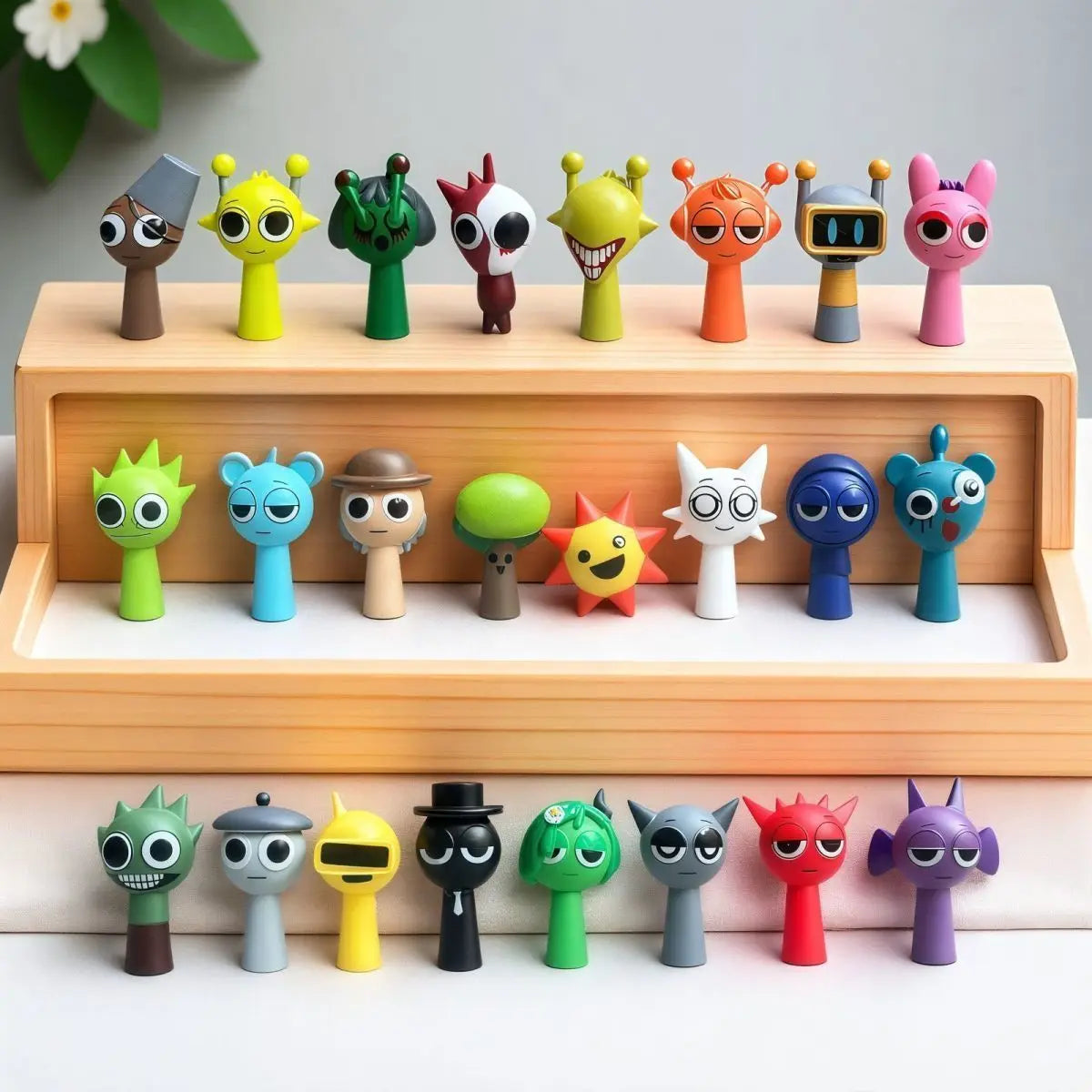 A collection of colorful handcrafted musical figurines in various animal shapes displayed on wooden shelves.