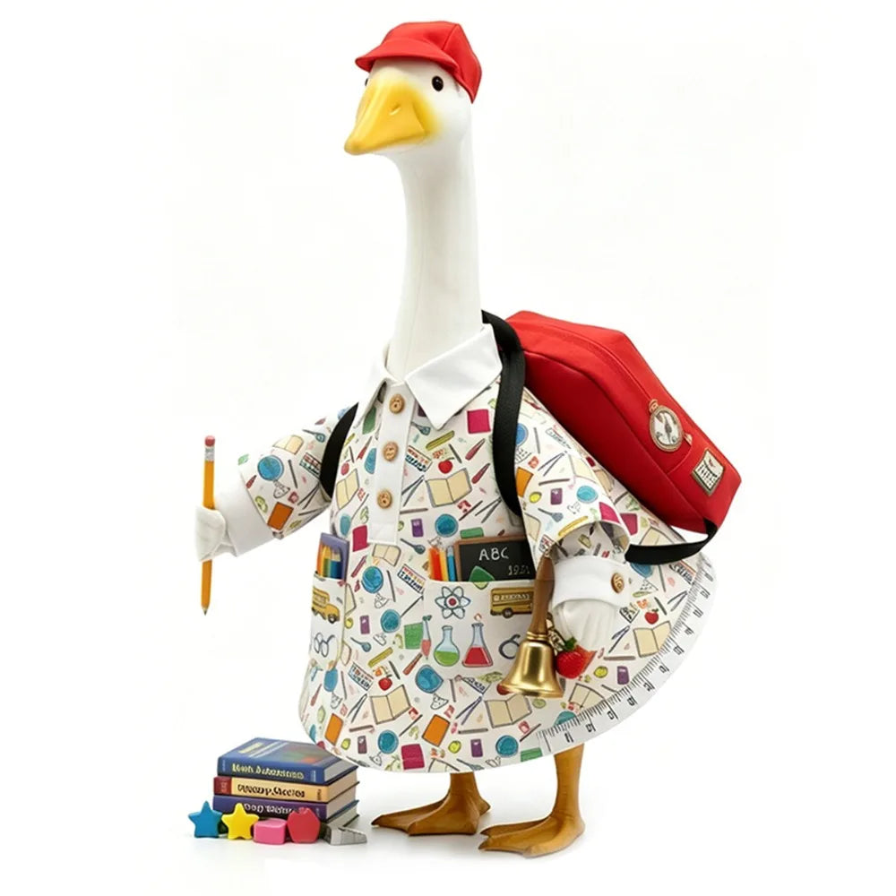 A white goose statue wearing a red cap and carrying a red bag, standing next to some books.