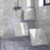 Modern bathroom or kitchen wall featuring large marble peel-and-stick panels in gray and white tones.
