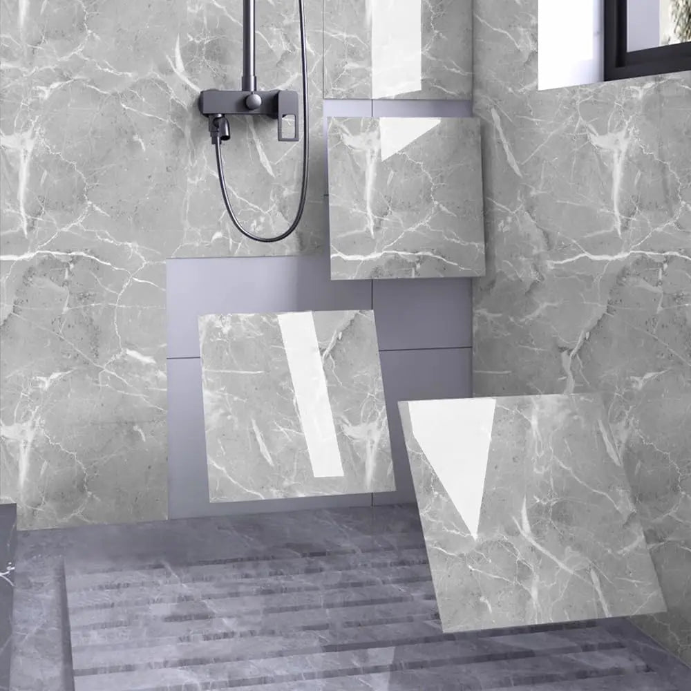 Modern bathroom or kitchen wall featuring large marble peel-and-stick panels in gray and white tones.