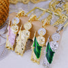 A collection of Saint Jude pendant necklaces featuring gold-plated finishes and various colored stones.