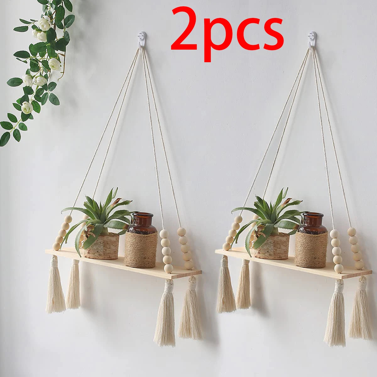Two macrame wood floating wall shelves with hanging rope displaying potted plants.
