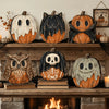 A set of vintage carved pumpkin decorations in various sizes and colors displayed on a wooden shelf.