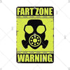 A vintage metal sign with a yellow background and black text warning about a fart zone.