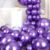 A cluster of metallic purple and silver balloons with confetti accents arranged in a balloon garland arch display.