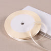 A roll of cream-colored satin ribbon on a white spool, ready for gift wrapping or DIY crafts.
