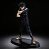 A dark figurine of a male character with spiky black hair in a fighting stance.