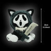 A plush toy of a cat wearing a black hood with white markings, shown against a dark background.