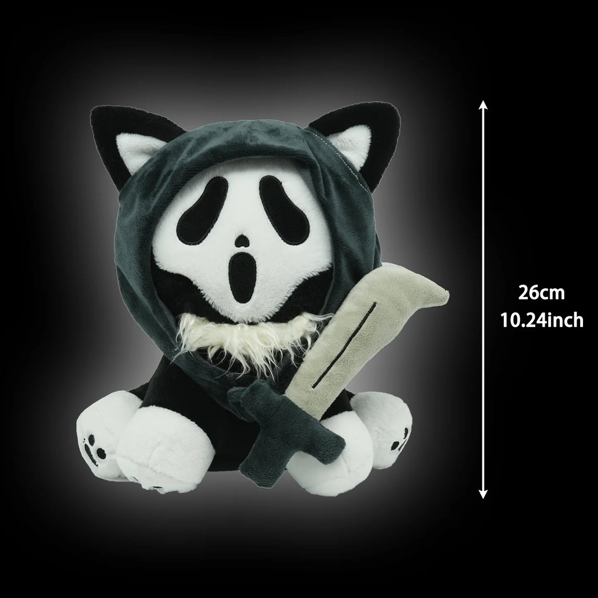 A plush toy of a cat wearing a black hood with white markings, shown against a dark background.