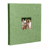 A green linen front scrapbook memory book with a photo of a family.
