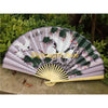 A large decorative Chinese theme wall fan with purple and green stripes featuring white cranes and foliage.
