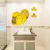 Yellow heart wall art decals displayed above a white sink on a bathroom vanity.