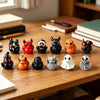Une collection de douze figurines mini à thème Halloween, de différentes couleurs et designs, disposées sur une table en bois