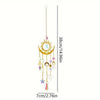A hanging gold flame moon crystal sun catcher with dangling charms.