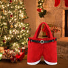 A set of six festive red Santa Claus gift bags displayed next to a decorated Christmas tree.