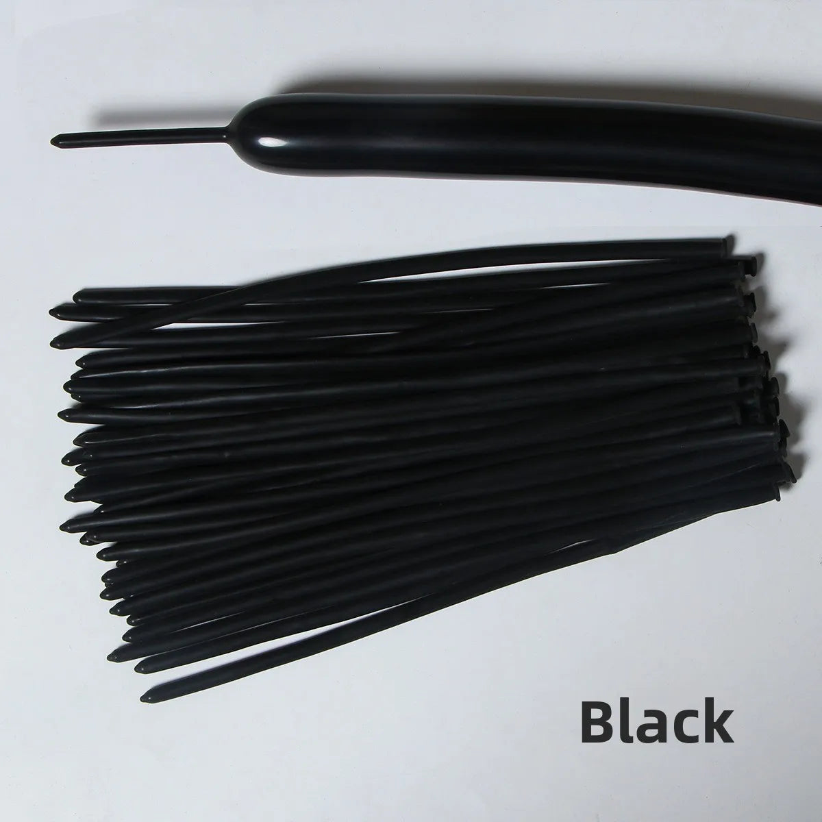 A black latex strip balloon and a bundle of black balloons for party decoration.