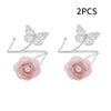 A set of two decorative flower butterfly curtain tiebacks in pink and silver.
