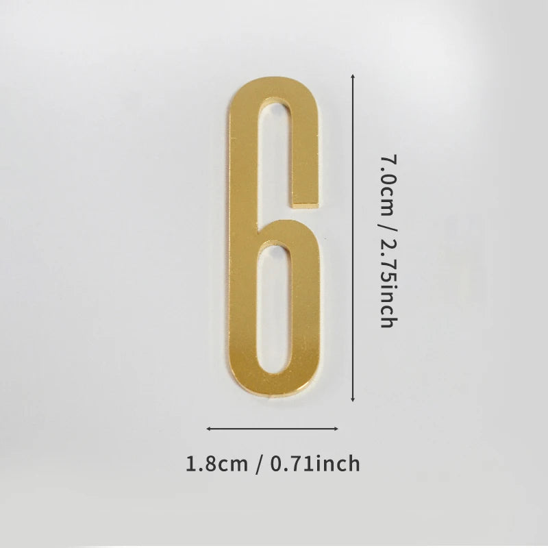 A polished gold house number six with a self-adhesive backing, measuring 7.0cm or 2.75inch high and 1.8cm or 0.71inch wide.
