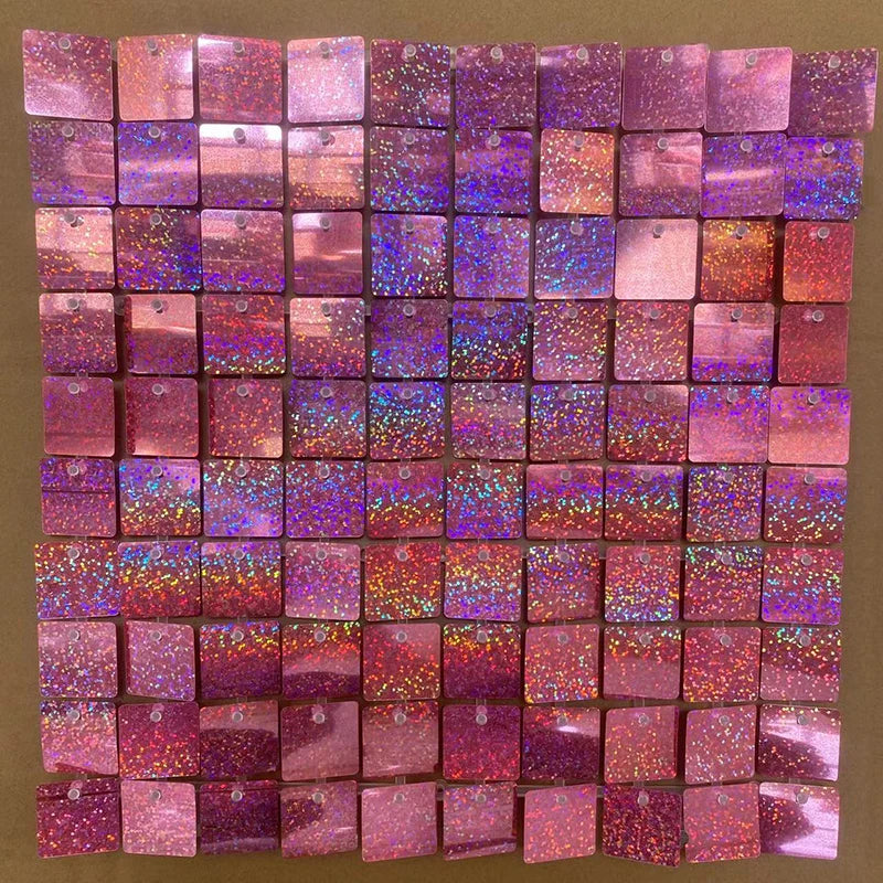 A grid of iridescent pink and purple sequin shimmer wall panels used as a sparkling backdrop.