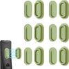 A set of magnetic silicone remote control holders in a light green color shown next to a black device.