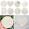 A collection of personalized newborn hospital keepsake signs featuring handprints and hearts on natural wood circles.